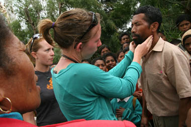 A medical volunteer consults patients in the rural village of Hatubilico