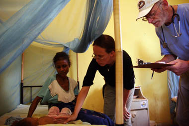 Doctors check on an infant